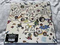 Front cover of Led Zeppelin III album, psychedelic artwork with butterflies and abstract designs, shrink wrapped