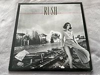 Front cover of Permanent Waves album showing black and white photo of woman and waves.