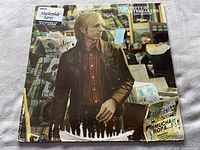 Front cover of 'Hard Promises' album showing worn edges and damage at the bottom