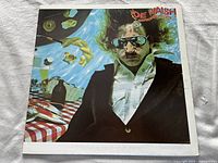 Front cover of 'But Seriously Folks' showing Joe Walsh in sunglasses with surreal poolside imagery