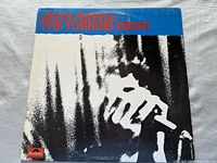 Front cover of John Mayall album 'The Turning Point' with black and white abstract art and blue red text.