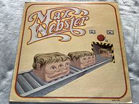 Front cover of Max Webster album showing illustrated heads on a conveyor belt with beige background, artwork intact but cover worn