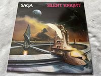 Front cover of Saga's Silent Knight vinyl album showing surreal sci-fi artwork with chess piece and moons.