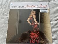 Front cover of the Diana Krall Christmas Songs vinyl album showing Diana Krall in a red dress, album title and artist name text.