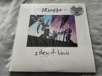 Front of the album cover showing Rush and A Show of Hands title, shrink wrapped.
