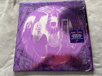Front cover of Smashing Pumpkins Gish album with band members in purple tint and a sticker noting remastered 180g vinyl reissue