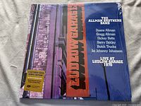 Front cover of the 3 LP vinyl album Live at Ludlow Garage 1970 by The Allman Brothers Band in original shrink wrap with a gold sticker noting remastering and 180g vinyl.