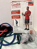 Box packaging of GoodLife Fitness resistance training bands showing light, medium, and heavy stretch tubing and exercise figures on the front.