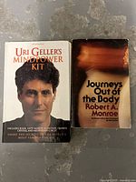 Photo of Uri Geller's Mindpower Kit book and Journeys Out of the Body book side by side showing front covers.