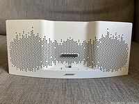 Front view of white Bose iPhone speaker dock showing dual speaker grilles and Lightning dock connector.