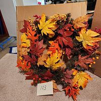 Front view of the autumn harvest wreath showing vibrant colored leaves and berries.