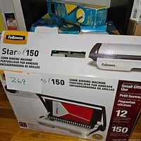 Closed box of Fellowes Star+ 150 comb binding machine with labels and specs visible