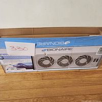 Front of the box showing Bionaire brand and image of the triple fan unit.