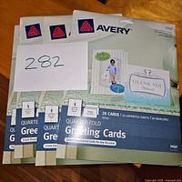 Photo showing 4 unopened packs of Avery blank quarter-fold greeting cards, each with 20 cards, envelopes and unprinted sheets.