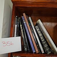 Photo of book lot showing titles on shelf, including Black American, Older Grace, Splendid Flowers, Songs of My People, The Blacklist, Crowns, and I Dream a World.