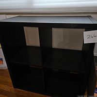 Front view of the brown wooden storage cube showing four compartments