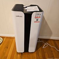 Front and top view of Cleanforce air purifier showing brand label and power cord on hardwood floor.