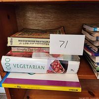 Stack of cookbooks including Moosewood Restaurant Low-Fat Favorites, Simply Vegetarian!, and 1000 Vegetarian