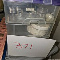 Photo showing the plastic organizer with compartments containing various crafting tools and supplies.