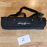 Closed black carrying case with Eddie Bauer logo on top showing compactness and brand