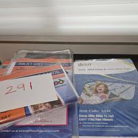 Multiple packs of blank inkjet greeting cards and a pack of double-sided glossy brochure photo paper.