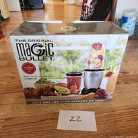 Sealed box of The Original Magic Bullet 11-piece blender set showing product image and branding