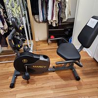 Full left side view of the Marcy recumbent exercise bike showing seat, pedals, and frame.