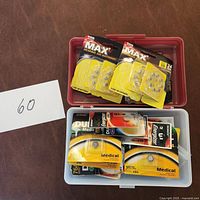 Top-down view of plastic boxes containing multiple packs of CVS Max hearing aid batteries and other medical batteries in original packaging.