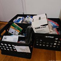 Two crates filled with assorted face masks including KN95 and Curad brands in original packaging.