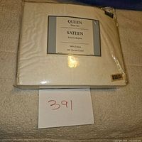 Photo of the queen sheet set packaging showing label details such as size, weave, material, and thread count.