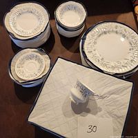 Overview of stacks showing teacups, saucers, dinner plates, salad plates and bowls in padded carrying cases