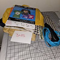 Lot contents with iron-on transfer sheets, fabric, scissors with blue cord, and papers visible