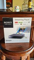 Front view of the Sony Streaming Player box showing product name and supported streaming apps logos including Netflix and Pandora.