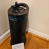 Front angled view of Therapure space heater showing the brand label and wrapped power cord on top.