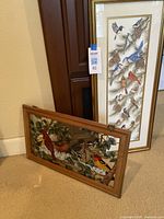 Photo showing both items side by side; stained glass bird panel and tall framed bird print.