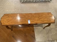 Overhead view of the rectangular wooden sofa table showing its wood grain and elegant brown finish.