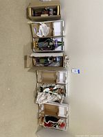 Five boxed nutcracker figurines arranged vertically on carpeted floor