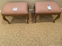 Photo of two vintage pink polka dot fabric footrests with wooden frames, side by side on carpeted floor