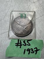 Photo of the 1937 Canadian Silver Dollar coin inside a transparent plastic holder with 'TD' green logo.