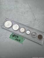 Set of six 1967 Canadian coins in a long transparent plastic holder with visible wear and scratches on surface