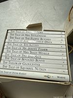 Top view of first book set containing 12 Beatrix Potter titles with white spines in a box