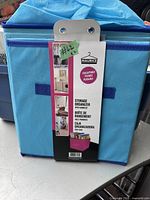 Photo of a blue collapsible storage organizer showing product label with Maurice branding and usage examples