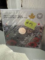 Photo of the coin mounted in original packaging with illustrated thematic card for The Battle of Vimy Ridge from 2017 by Royal Canadian Mint.