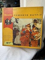 Original Kodak Brownie Hawkeye Outfit box with a photo of a marching band on the cover and branding.