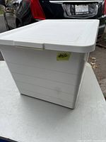 White plastic storage tote with a lid viewed from an angle showing dimensions and general condition.