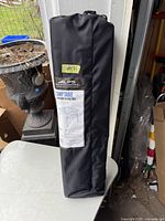 Black carrying bag with product label for ALPS Mountaineering Camp Table