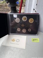 Front view of the Canadian 2017 specimen coin set displayed in its protective holder alongside the certificate of authenticity card.