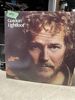 Front cover of the Gordon Lightfoot Gord's Gold vinyl record album showing the artist's face close up with text.