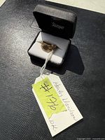 Ring and case with hang tag reading #176 10K