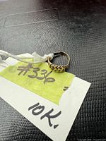 Ring on tag showing braided band pattern and overall shape